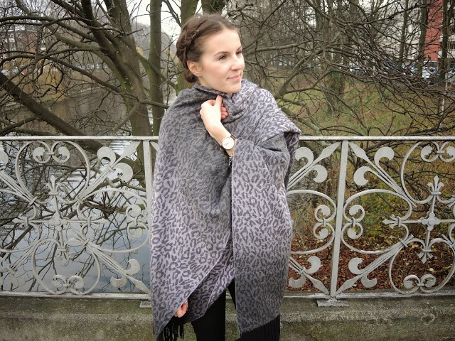 Model wearing grey poncho