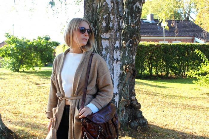 Blond girl wearing beige cardigan